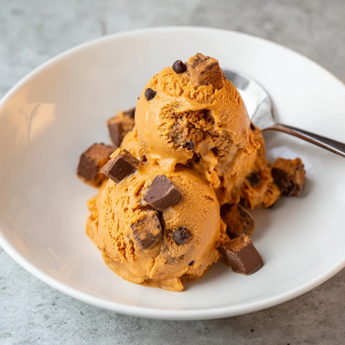 Creamy Pumpkin Chocolate Chip Muffin Ice Cream topped with crunchy muffin pieces.
