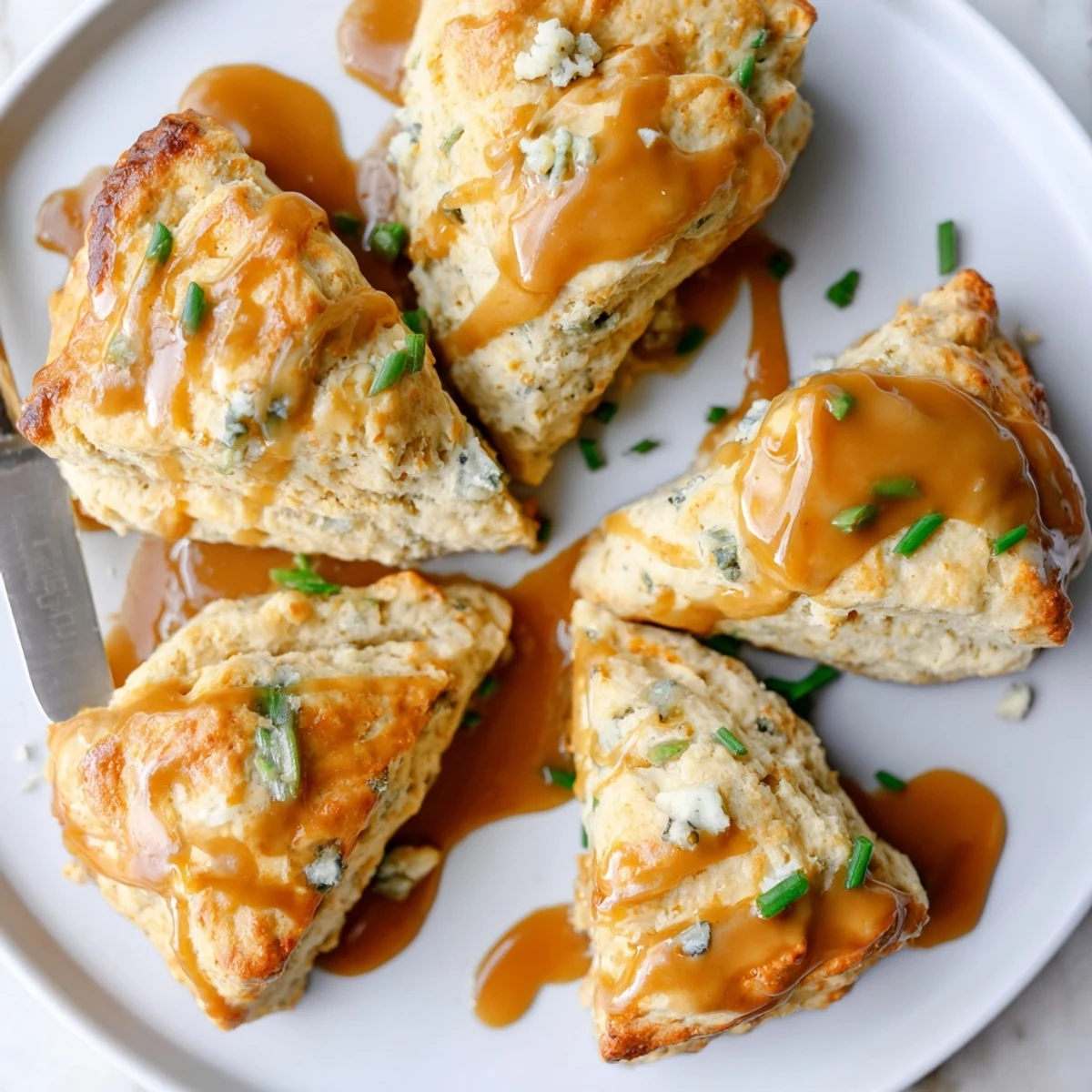 Buttery Buffalo Ranch Chai Caramel Biscuit Scones drizzled with rich caramel sauce.  