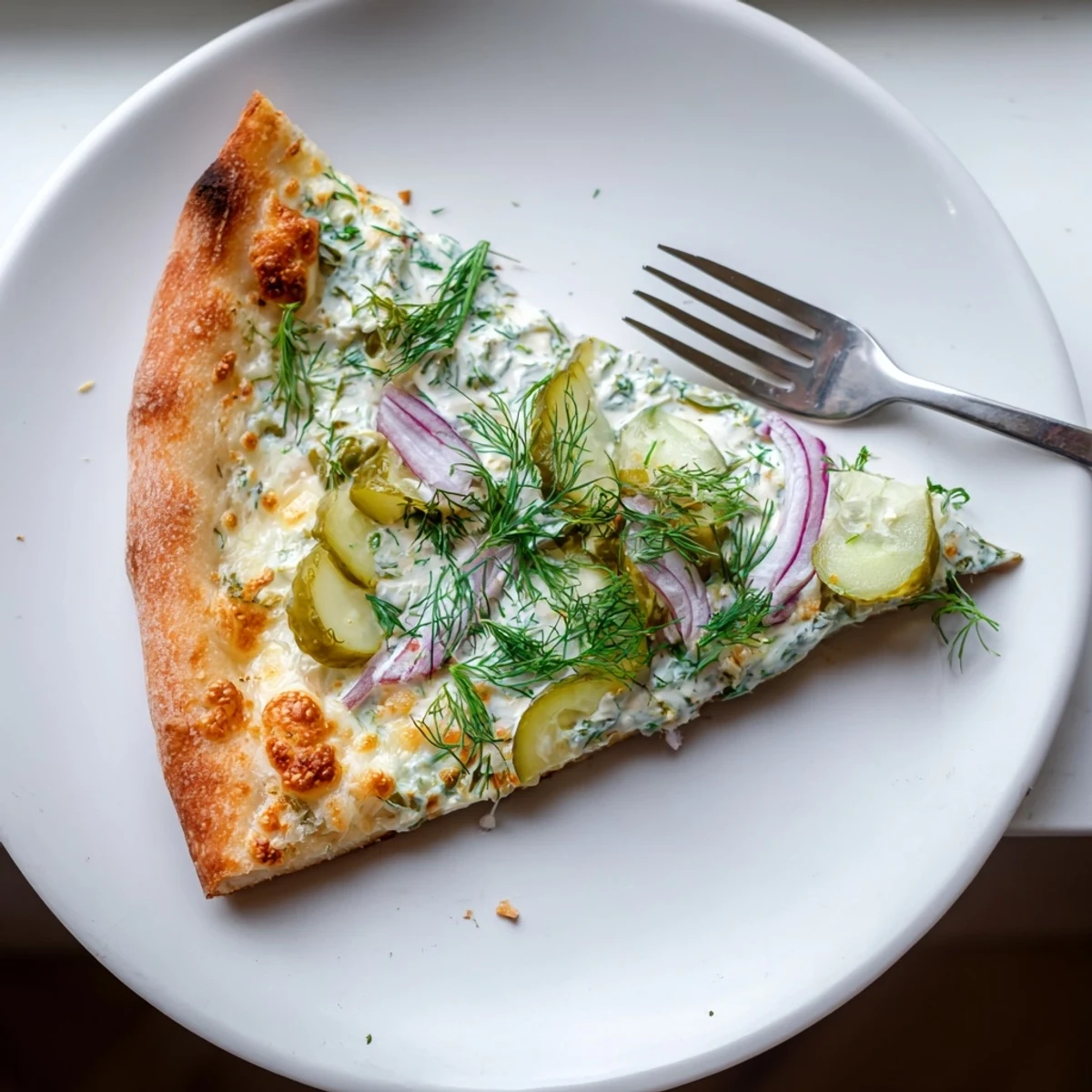 Deliciously unique Pickle Pizza garnished with fresh dill and crispy dill pickles.  