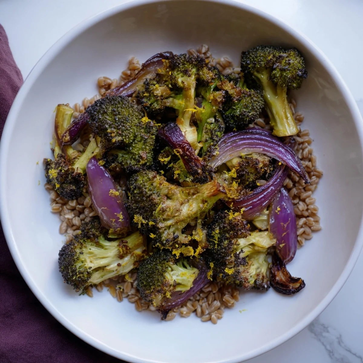 Golden roasted broccoli with garlic-lemon dressing served over fluffy farro; a delicious Mediterranean-inspired dish.