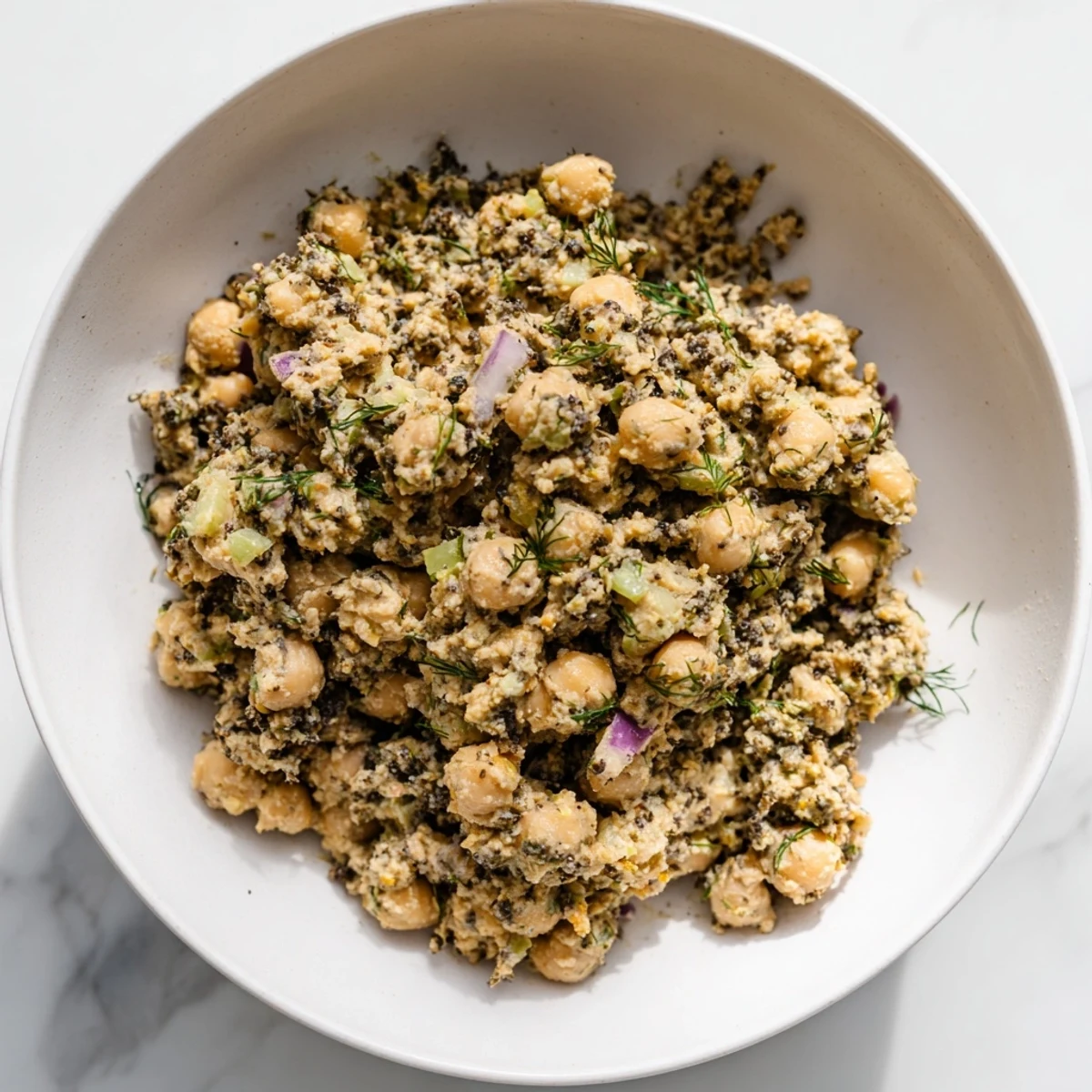 Chunky chickpea tuna salad with a vibrant medley of diced veggies, perfect for a light lunch.