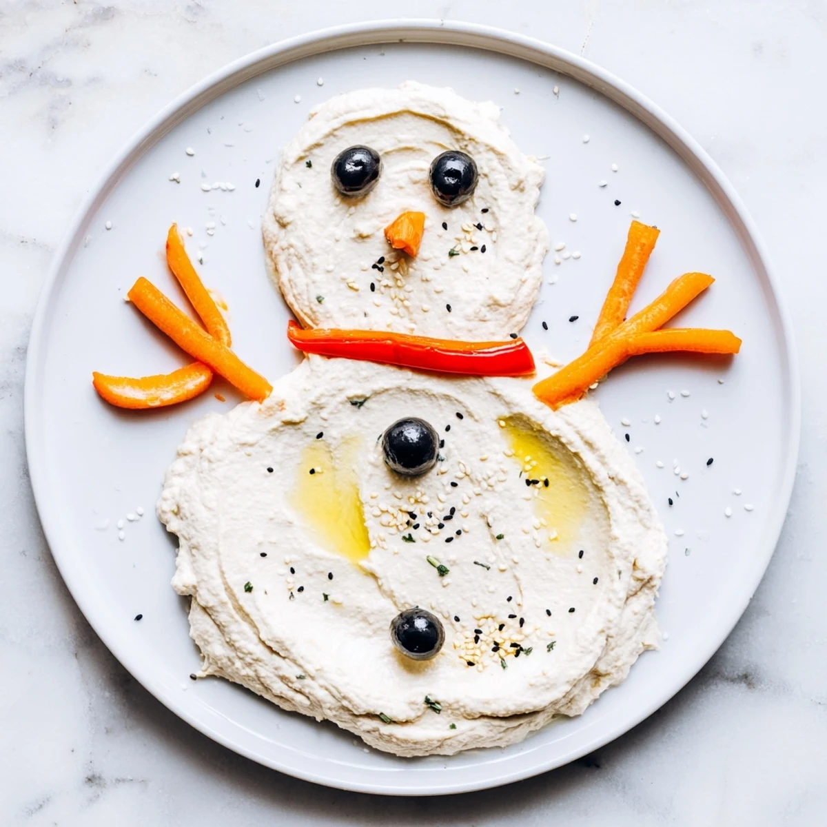 Homemade melted snowman hummus recipe, ready to serve with fresh vegetable dippers for everyone.