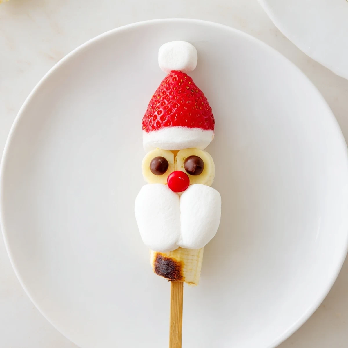 Close-up of colorful Banana Santa Snack Sticks, easy, healthy, and fun fruit skewers for kids' snacks.