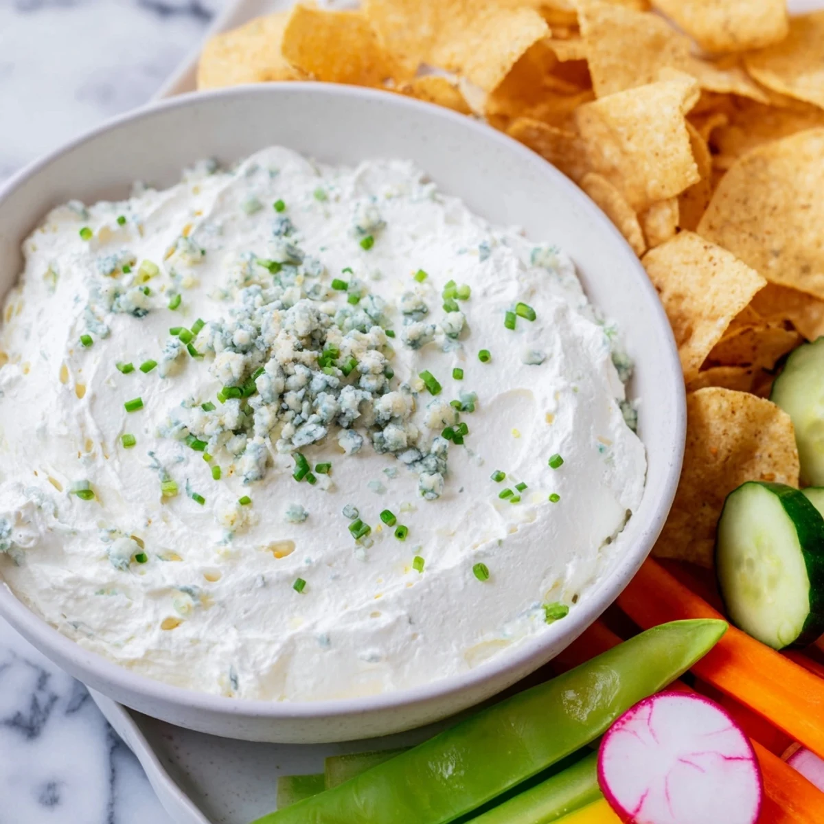 Creamy blue cheese dip, shaped like a pond, surrounded by fresh veggies, a perfect Frozen Pond Blue Dip Platter.