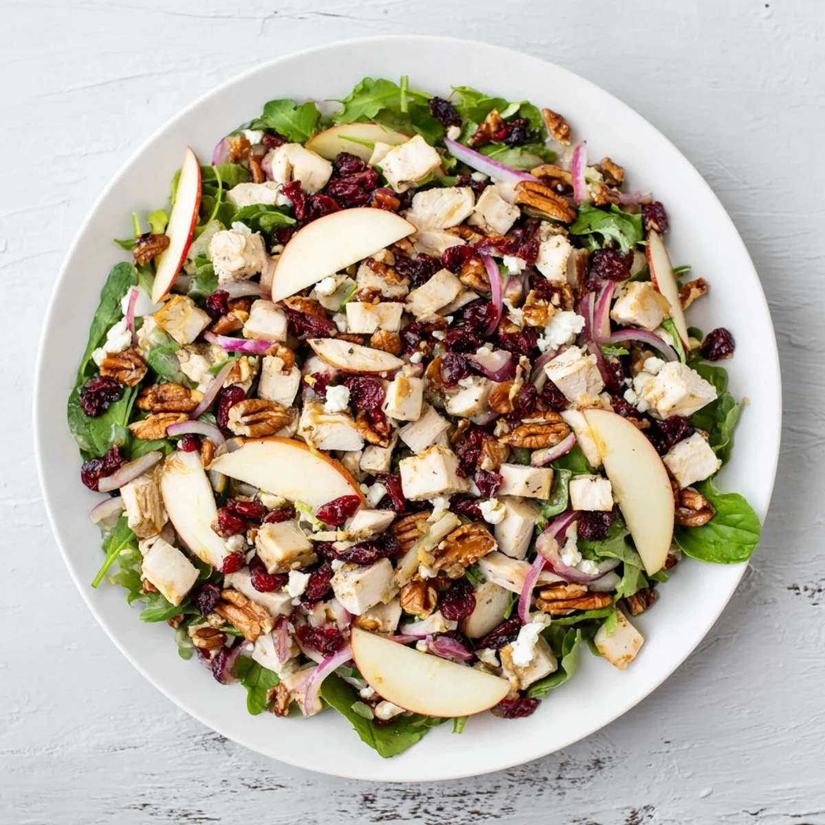 This Chicken and Apple Winter Salad shows crisp apple slices and shredded chicken tossed in a tangy dressing.