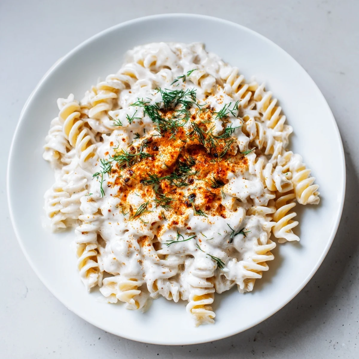Homemade Turkish Yogurt Pasta, featuring fusilli covered in a tangy yogurt sauce, served in a bowl.