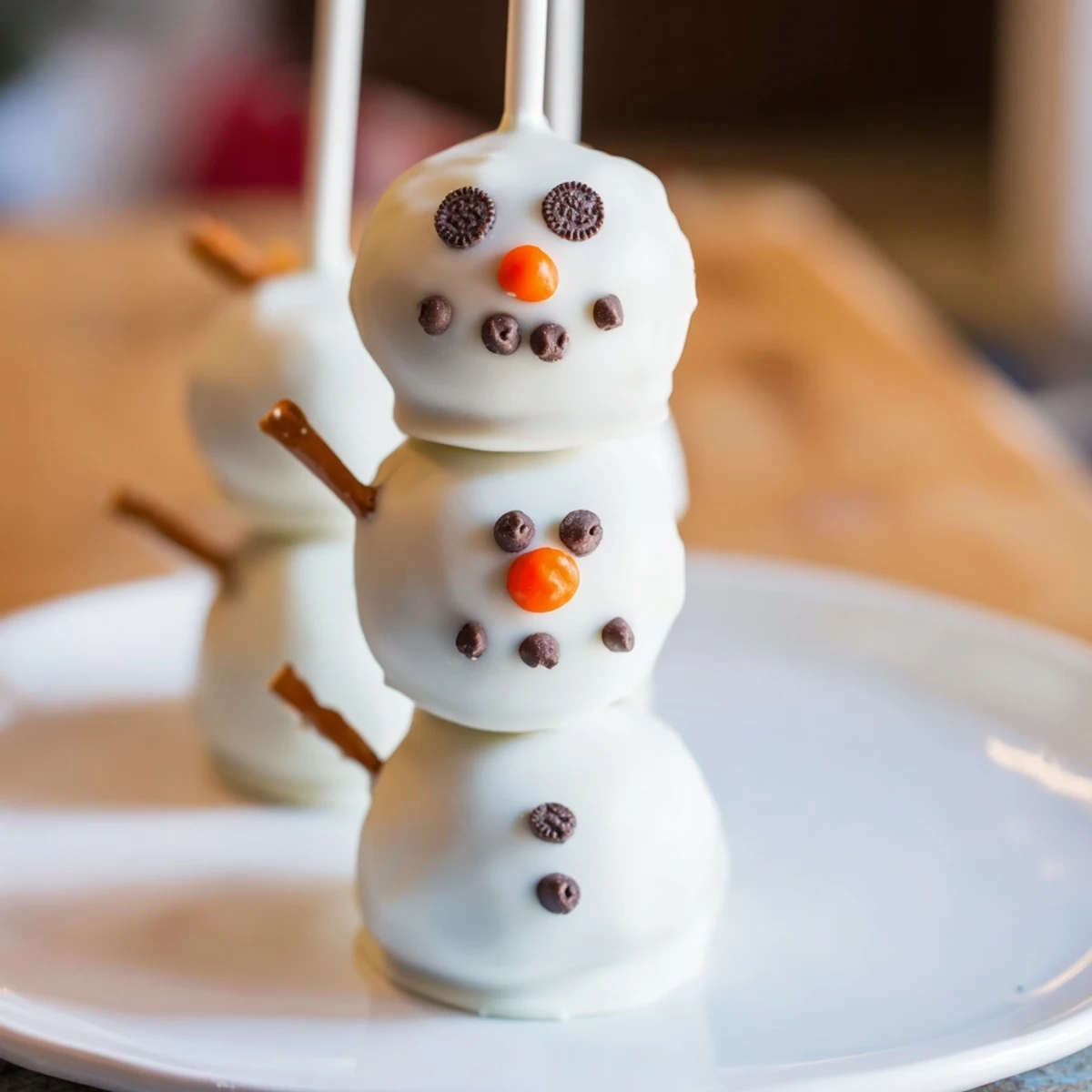 Close-up of cute, homemade Oreo Snowman Cake Pops, ideal winter dessert for all ages.