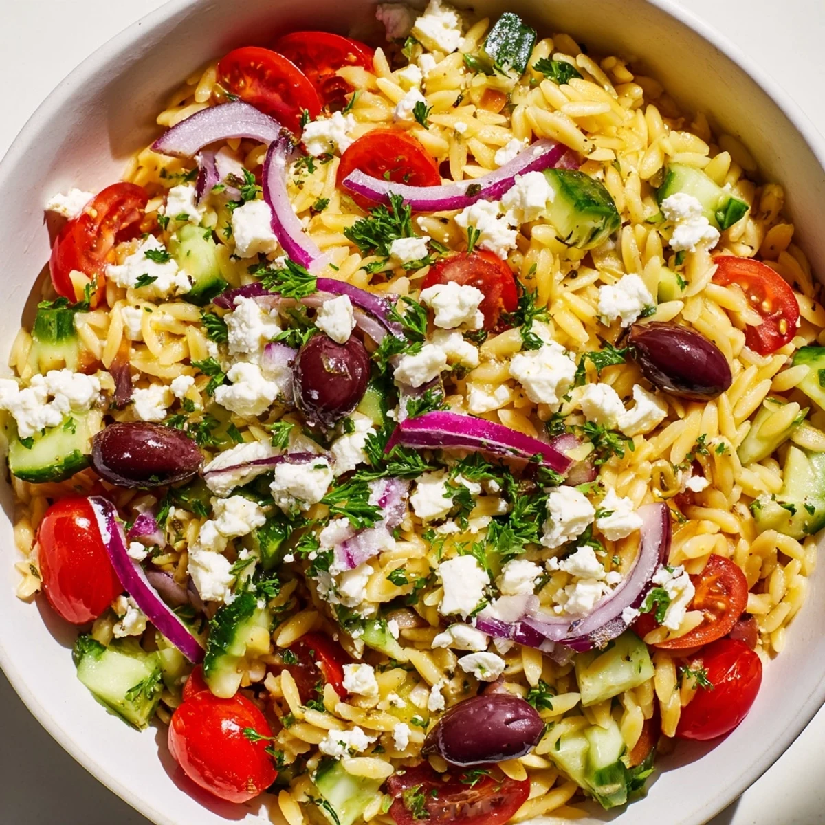 This refreshing vegetarian Greek Orzo Salad is packed with tender pasta, diced vegetables, and tangy feta, ready for a picnic side dish.