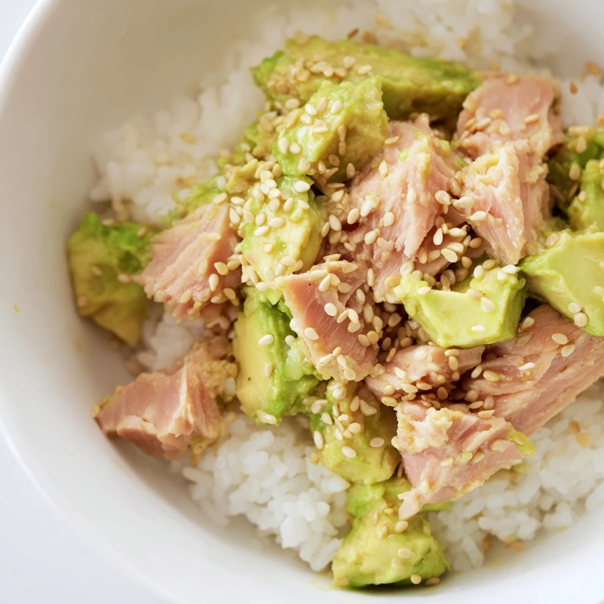 Fragrant jasmine rice topped with flaked tuna, creamy avocado, crisp cucumber, and a drizzle of savory sesame-ginger dressing in this Tuna Avocado Rice Bowl.