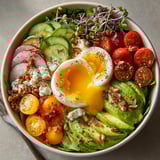 Close-up of a vibrant Microgreens Breakfast Bowl ready to eat, showcasing textures and fresh ingredients.