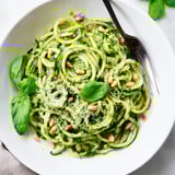 A delightful plate of zucchini noodles with aromatic basil pesto and toasted nuts.