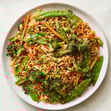 Vibrant photo of a plate of delicious Ramen Noodle Stir-Fry Remix, ready to eat with sesame seeds.