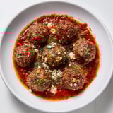 Warm, vibrant Instant Pot Greek Meatballs, served with a dollop of tangy lemon-feta, perfect for dinner.