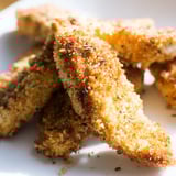 Perfectly baked Crispy Panko Chicken Strips served with a dipping sauce and fresh lemon wedges.  
