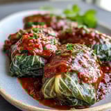 Savory lentils and brown rice fill Baked Vegan Cabbage Rolls, served hot alongside crusty artisan bread.