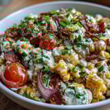 Spicy and refreshing, this Creamy Corn Salad with Jalapeño features juicy tomatoes and zesty lime for a perfect barbecue side.  