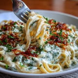 Velvety Alfredo pasta with shredded cabbage, garlic, and cream cheese for a comforting vegetarian main dish.  