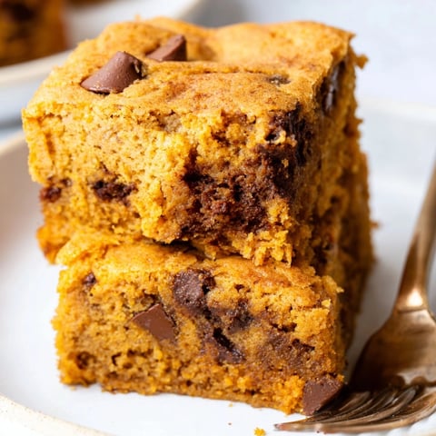Golden Chocolate Pumpkin Chip Blondies, warm from the oven, speckled with melted chocolate.