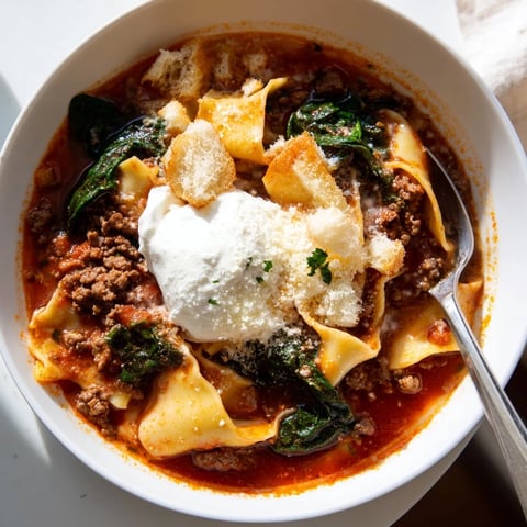 Hearty lasagne soup garnished with roasted garlic croutons and creamy ricotta.  