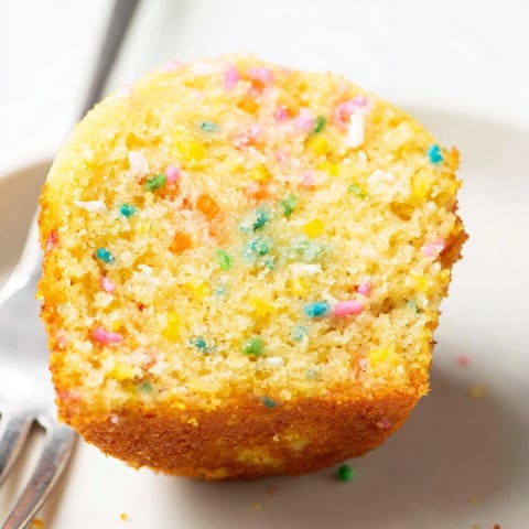 Sweet Funfetti cornbread muffins topped with vibrant sprinkles for festive occasions.  