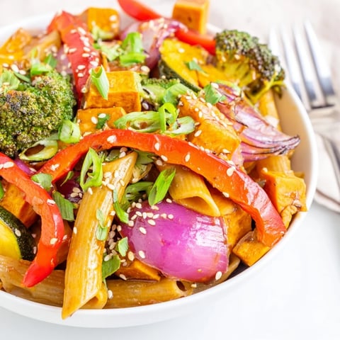 Colorful Miso Maple Roasted Veggie Pasta topped with sesame seeds and fresh herbs.  