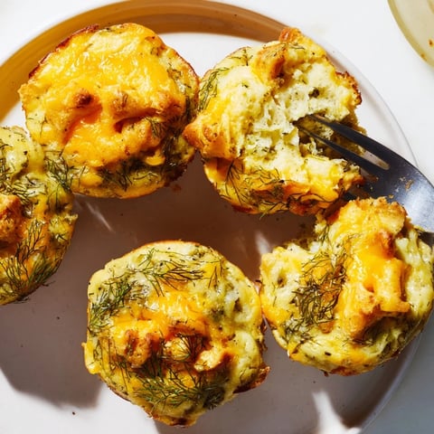 Savory Dill Pickle Cheddar Pretzel Pancake Muffins topped with crunchy pretzels and cheese.  