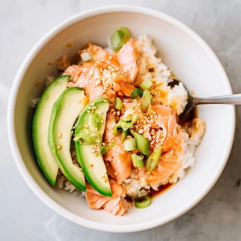 Delicious leftover salmon and rice bowl topped with fresh avocado and cucumber.  