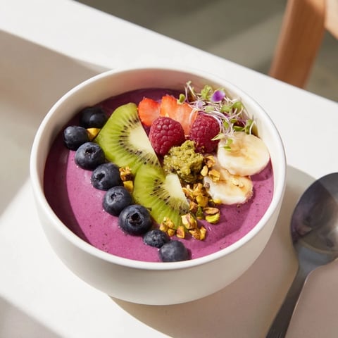 Vibrant smoothie bowls with purple yam and fresh berries, a perfect healthy breakfast.  