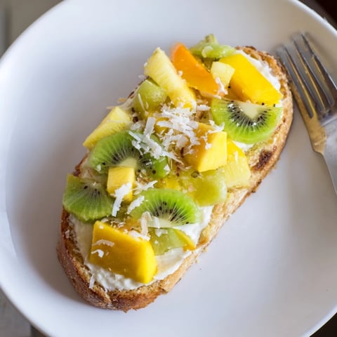 Vibrant Yogurt-Custard Toast 2.0 topped with fresh tropical fruits and coconut.  