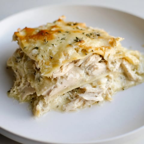 Golden, bubbly rosemary chicken lasagna, fragrant and brimming with tender chicken and creamy sauce.