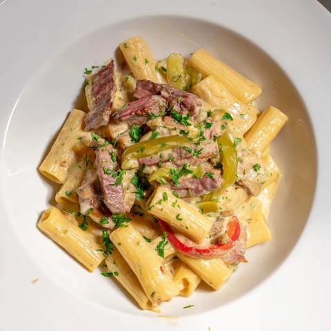Philly Cheese Steak Pasta: A creamy bowl of pasta with tender beef and melting cheese.