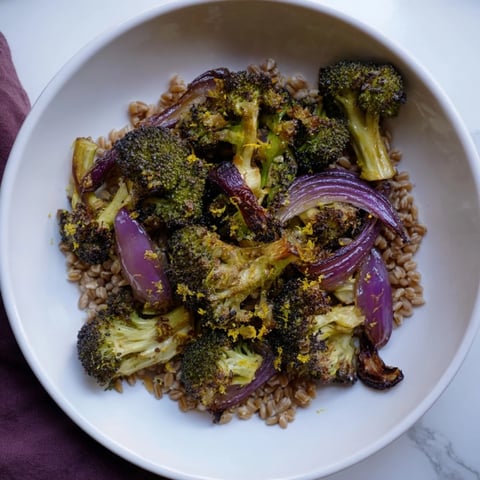 Golden roasted broccoli with garlic-lemon dressing served over fluffy farro; a delicious Mediterranean-inspired dish.