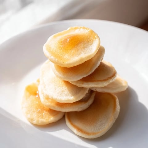 Golden and fluffy pancake cereal, perfect mini pancakes ready to eat with syrup and milk.