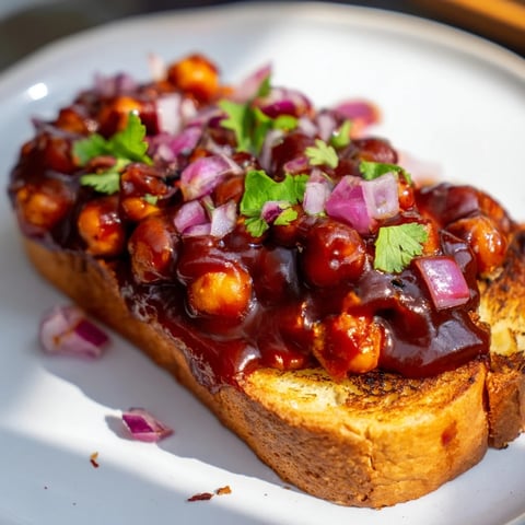 Golden, crispy toast piled high with flavorful and tangy BBQ chickpeas, ready to eat!
