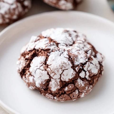 Air-Fried Chocolate Crinkle Cookies: A close-up view of crackled, powdered sugar-dusted, homemade cookies.