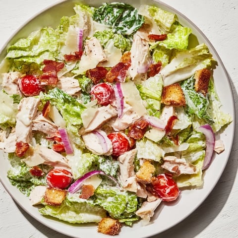 Costco Chicken Bake Salad Bowl brimming with roasted chicken, bacon, and creamy Caesar dressing, ready to enjoy.