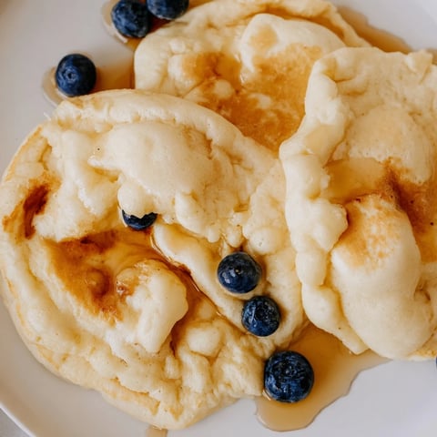 Golden, scrambled fluffy pancakes served warm with maple syrup, a delightful one-bowl breakfast.