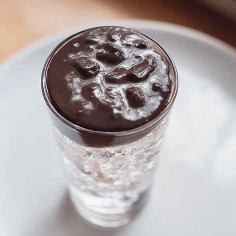 Rich, dark chocolate cracks atop the creamy Chocolate Cracking Iced Latte, a perfect summer treat.