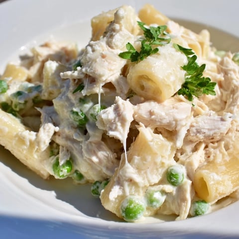Golden-brown Slow Cooker Chicken Alfredo Pasta Bake, oozing with creamy cheese and tender pasta.