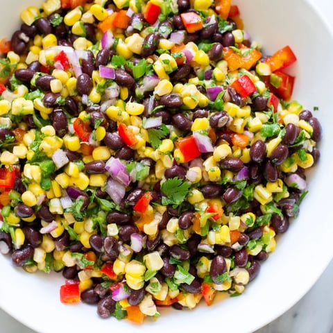 A colorful bowl of Cowboy Caviar Salad, bursting with fresh Southwestern flavors and textures.
