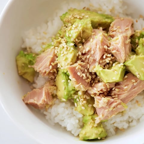 Fragrant jasmine rice topped with flaked tuna, creamy avocado, crisp cucumber, and a drizzle of savory sesame-ginger dressing in this Tuna Avocado Rice Bowl.