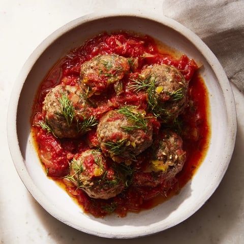 Instant Pot Greek Meatballs with Lemon-Feta Sauce, rich tomato sauce coats tender meatballs, topped with creamy feta.