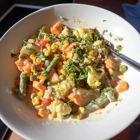 A steaming bowl of colorful Veggie Coconut Curry, perfect for a cozy weeknight dinner experience.