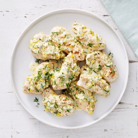 A close-up of plated Lighter Creamy Tarragon Chicken, garnished with fresh tarragon and parsley.