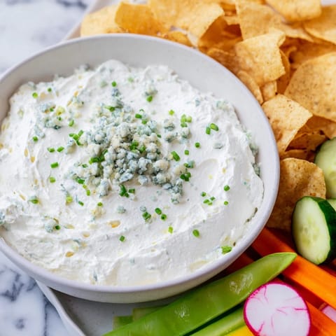 Creamy blue cheese dip, shaped like a pond, surrounded by fresh veggies, a perfect Frozen Pond Blue Dip Platter.