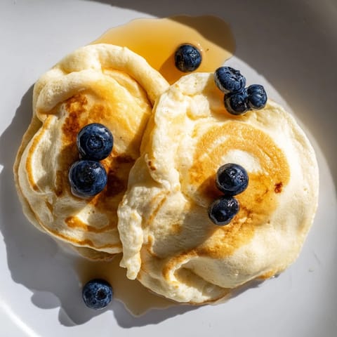 These soft and tender fluffy scrambled pancakes are cooked to a light golden brown, ready to enjoy.