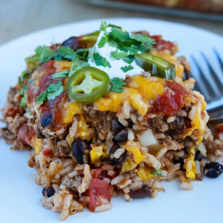 Colorful layers of Tex-Mex Beef & Rice Casserole with rich flavors and spices throughout.  