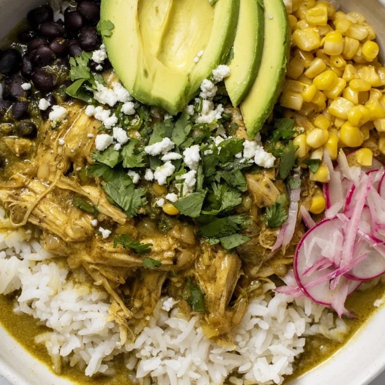 Warm and savory Green Enchiladas Rice Bowl boasts fluffy rice, tender chicken, and fresh cilantro garnish.