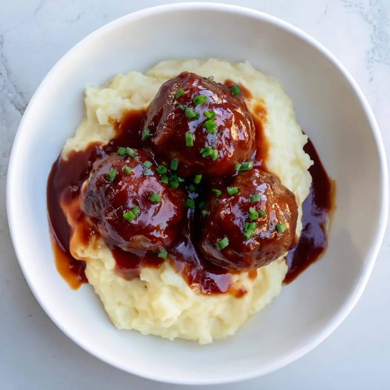 Warm, comforting BBQ Meatballs & Mashed Potatoes, ready to be enjoyed with a perfect balance of flavors and textures.