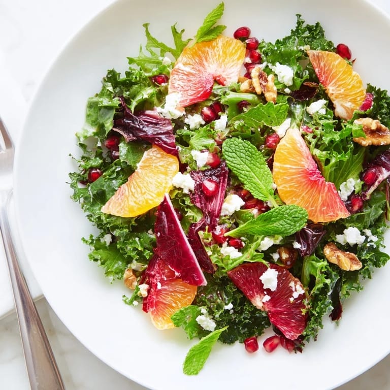 A refreshing close-up of Winter Greens Salad with creamy optional feta cheese and citrus.